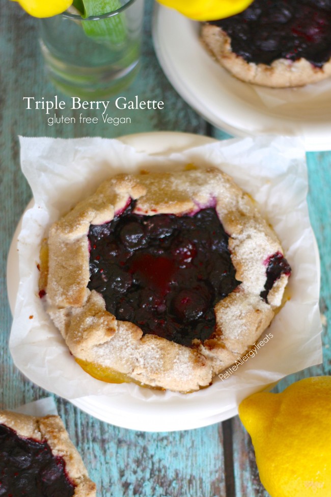 Gluten Free Triple Berry Galette- Bursting with blueberries, strawberries and raspberries this galette is a simple way to impress company. Vegan, egg free, dairy free
