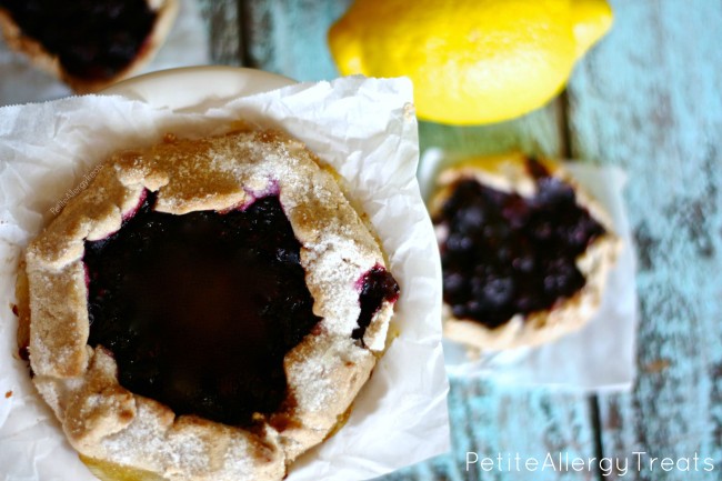 Gluten Free Triple Berry Galette- Bursting with blueberries, strawberries and raspberries this galette is a simple way to impress company. Vegan, egg free, dairy free