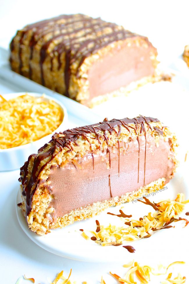 Gluten Free Dairy Free Samoa Ice Cream Cake Recipe (Vegan)- Crunchy toasted coconut, sweet caramel with cookie crumb bottom make this dairy free chocolate ice cream cake irresistible. Food Allergy friendly.